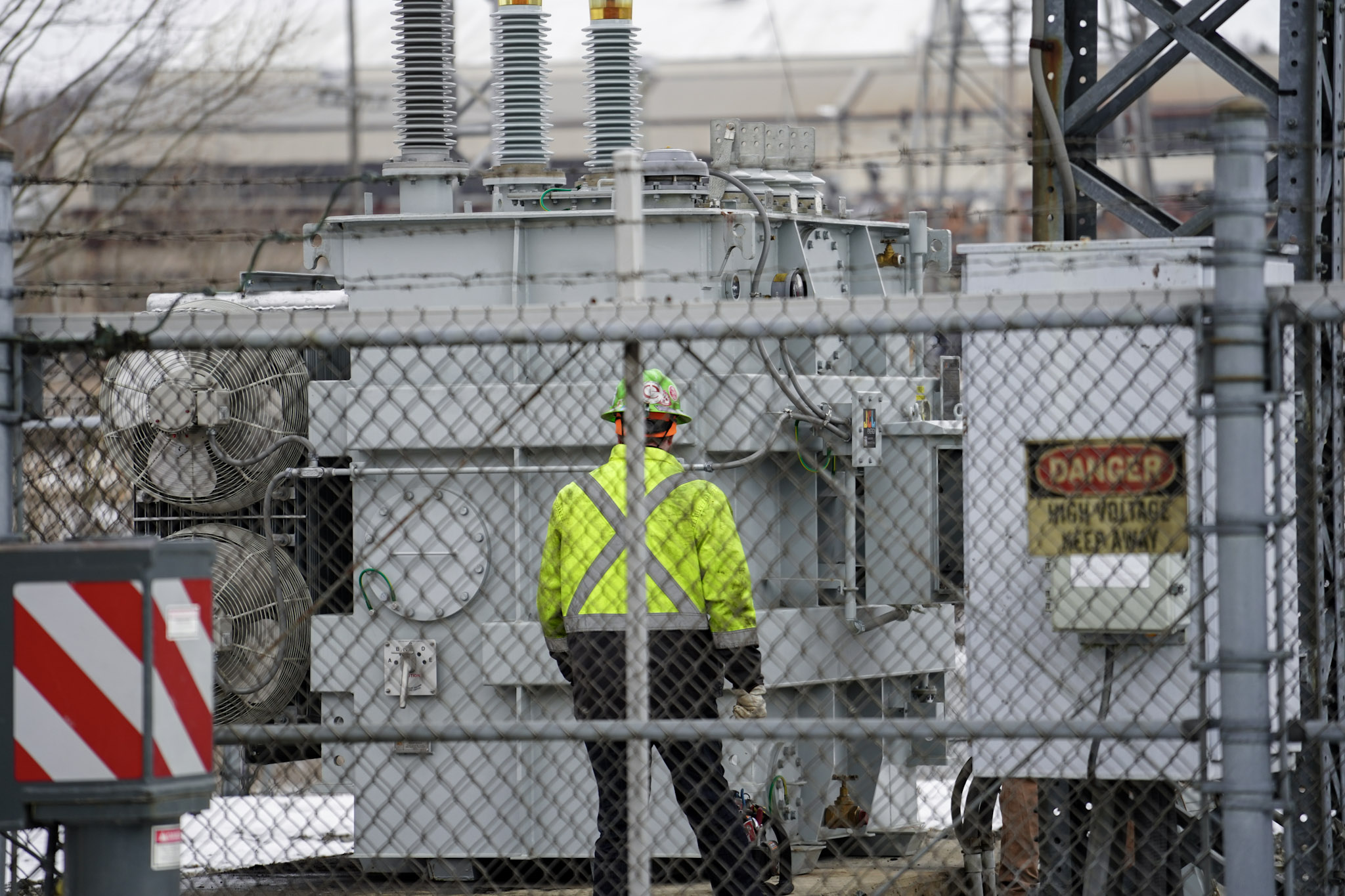 JCL technician at an energized substation transformer