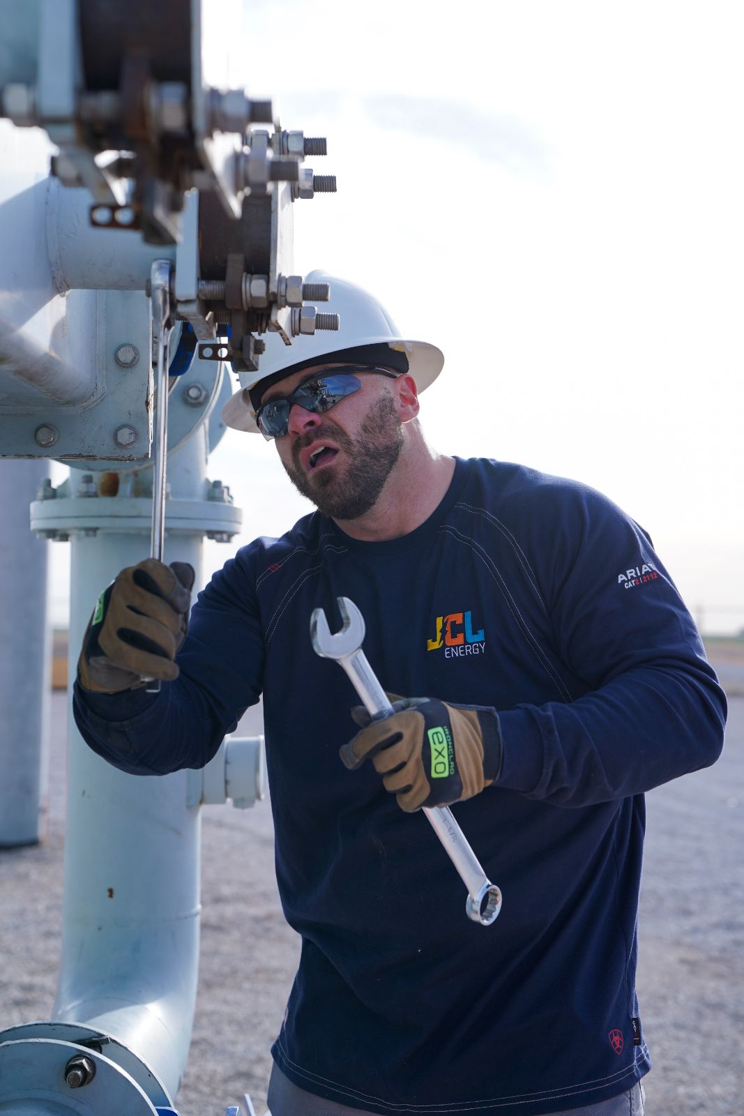 A JCL technician mid-service with a wrench