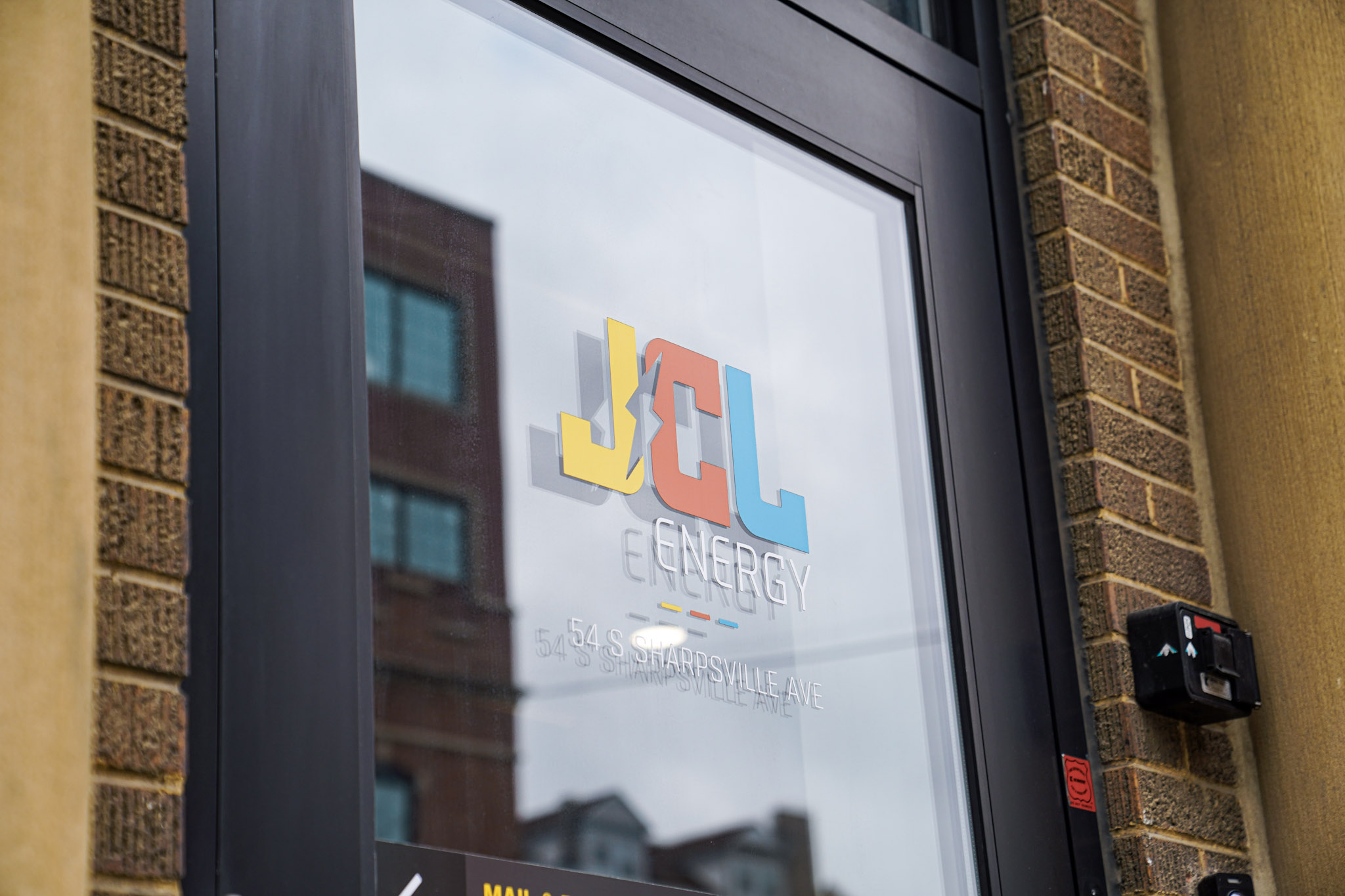 The JCL Energy logo on the glass entrance of the Sharon, PA headquarters