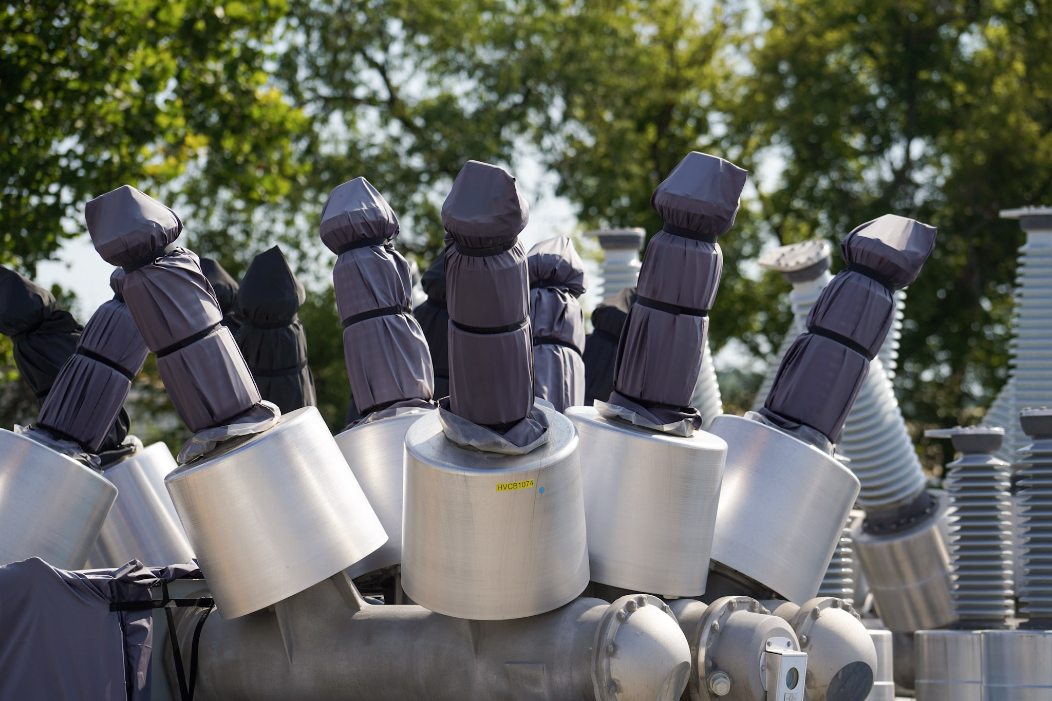 High-voltage breaker bushings wrapped for protection in the JCL yard