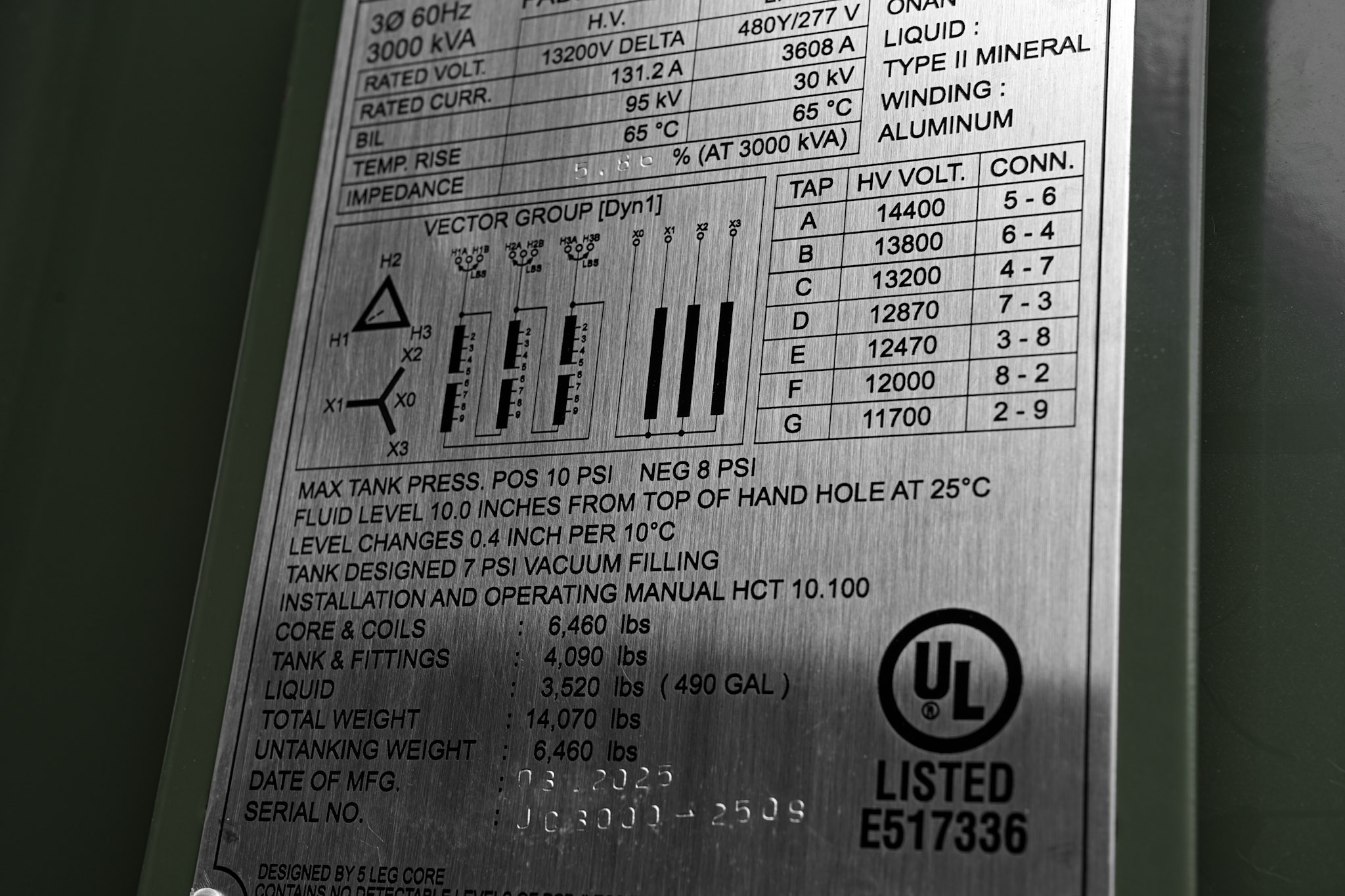 A padmount transformer nameplate with ratings and tap table