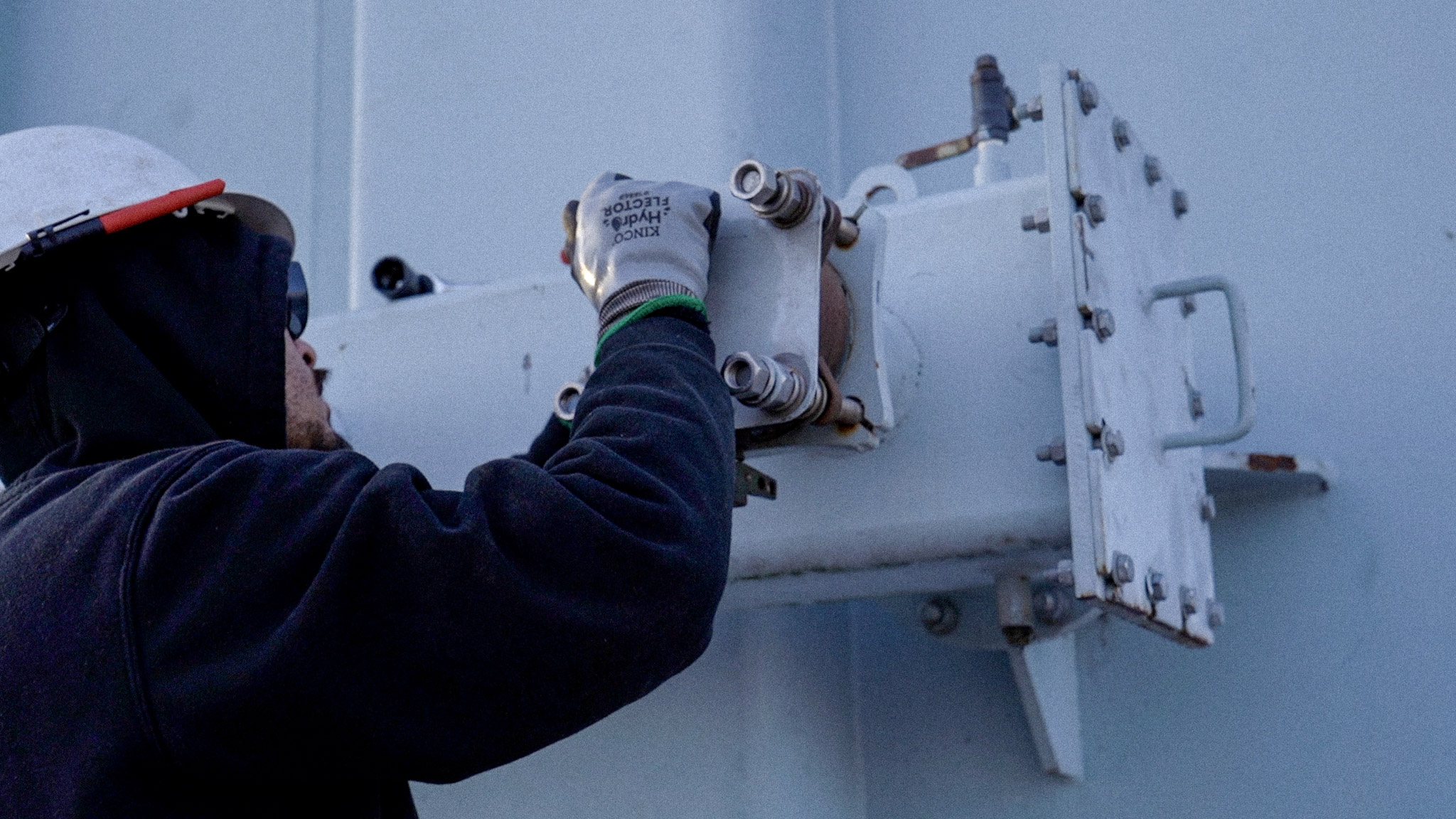 JCL technician connecting a fluid processing hose