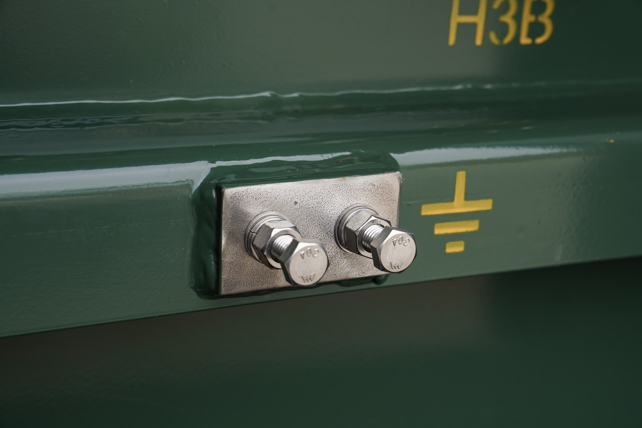 Ground strap connector beside the stenciled ground symbol