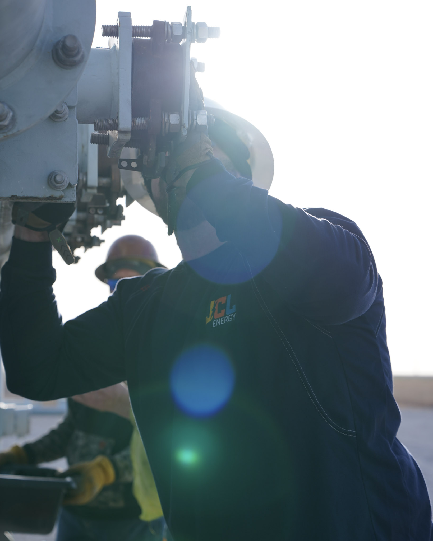 A JCL technician working against the sun to restore power