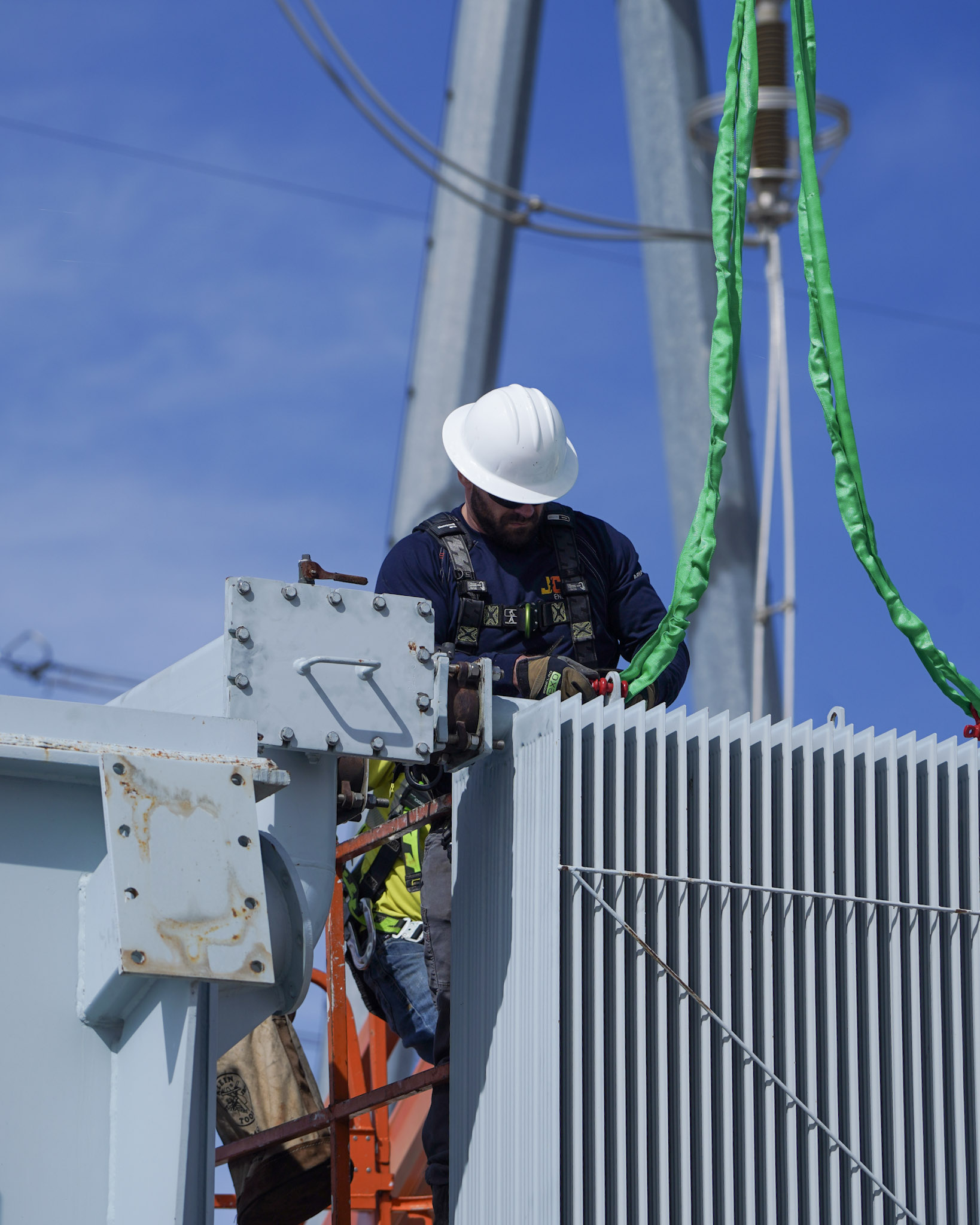 JCL technician rigging a power transformer at a substation