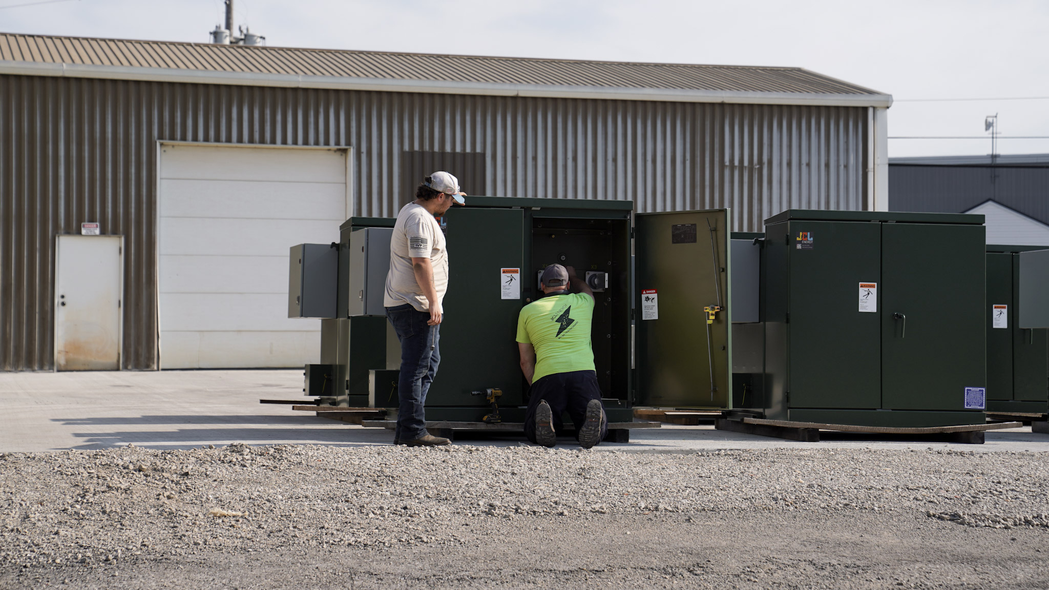 Two JCL specialists working an open padmount transformer